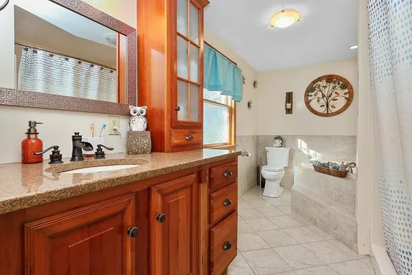 a spacious bathroom with a sink a mirror and a toilet