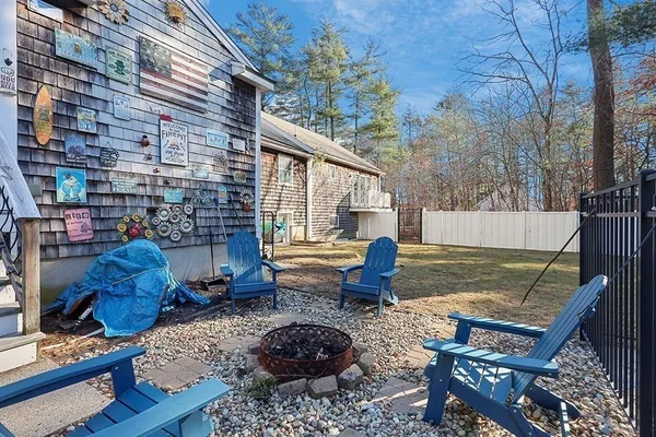 a view of backyard of house with seating space