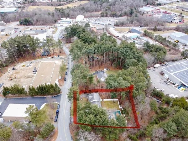 an aerial view of a house with a yard and lake view