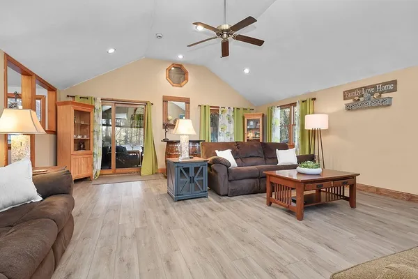 a living room with furniture and wooden floor