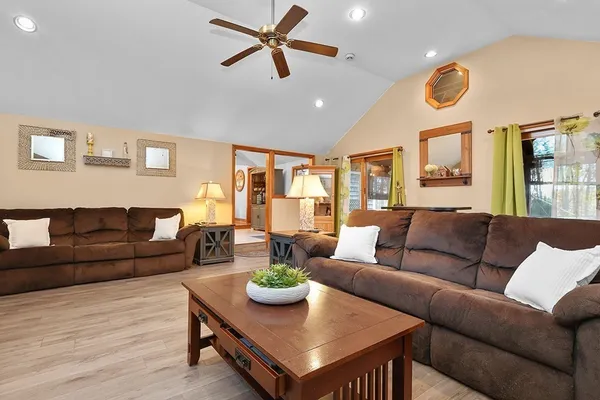 a living room with furniture and a wooden floor