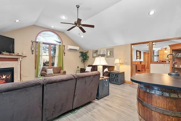 a living room with furniture a fireplace and a flat screen tv