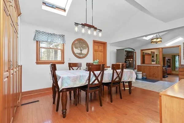 a dining room with furniture and a clock