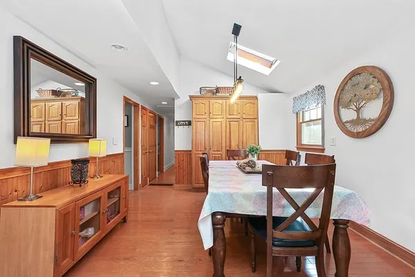 a view of a dining room with furniture and a chandelier