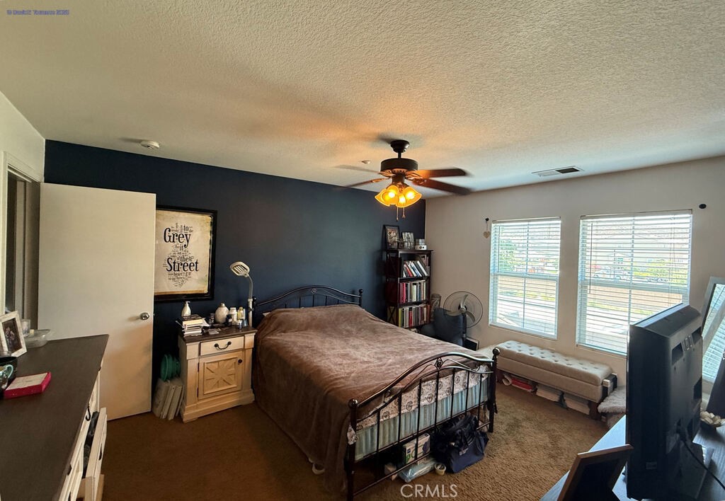 31771 Biagio Way Winchester, CA 92596 - Photo 17 of 44 a bedroom with a bed and a flat screen tv