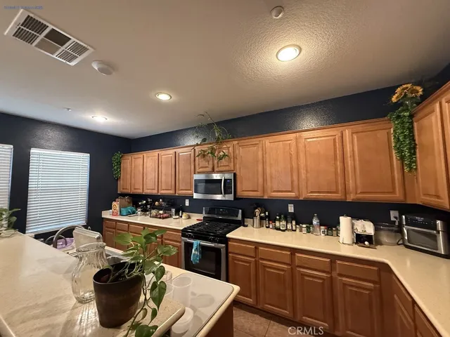 a kitchen that has a sink cabinets counter space and a window