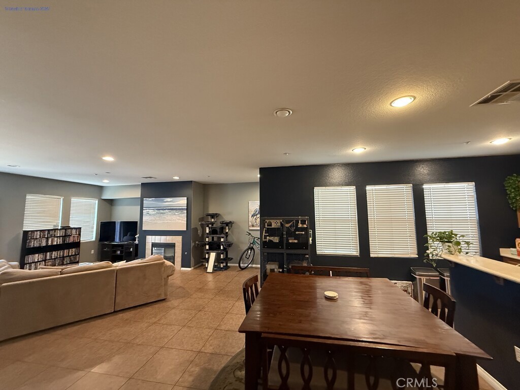 31771 Biagio Way Winchester, CA 92596 - Photo 8 of 44 a kitchen with stainless steel appliances granite countertop a stove a refrigerator a sink a dining table and chairs