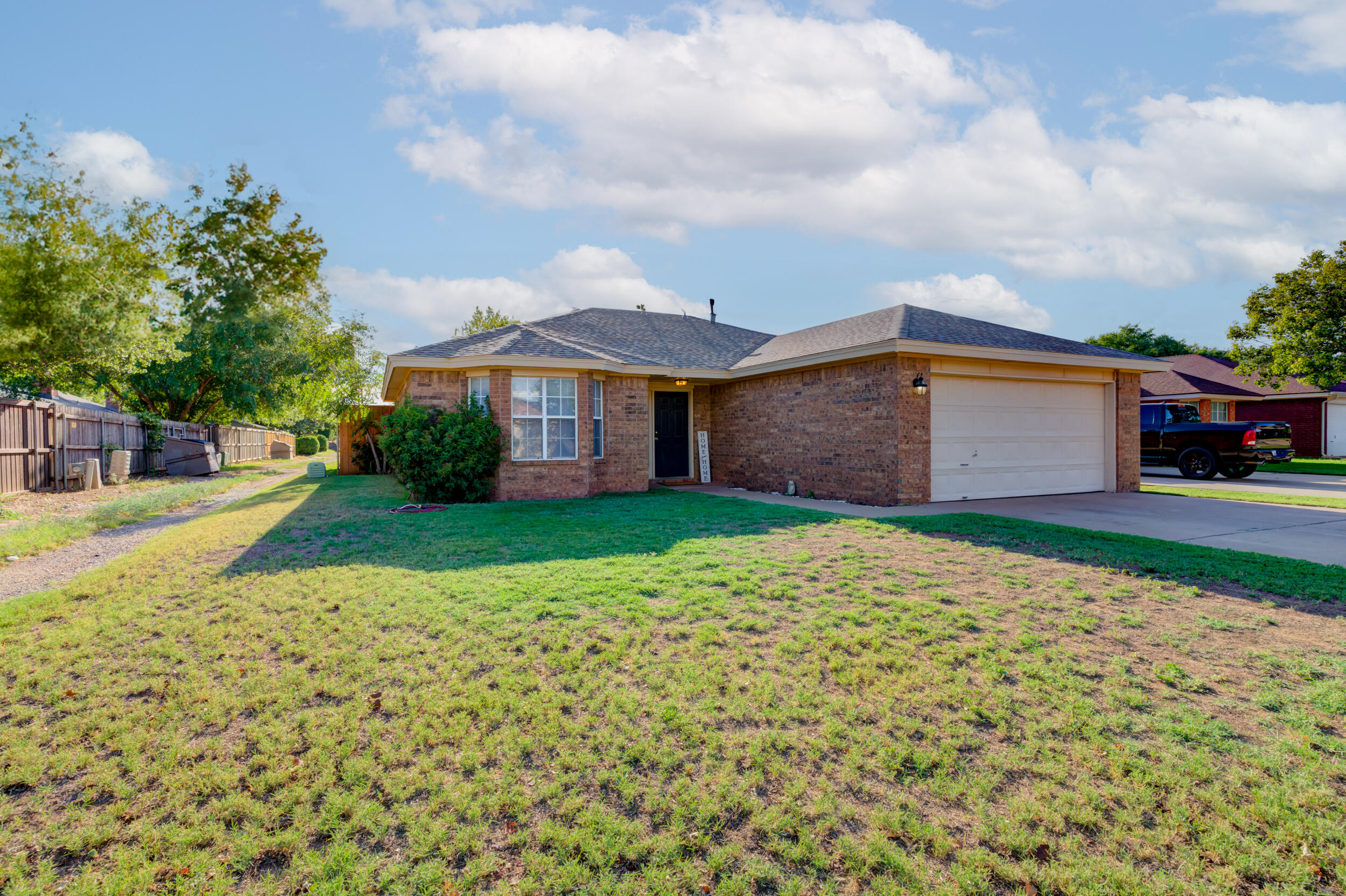 8406 Canton Avenue Lubbock, TX 79423 - Photo 1 of 25 a front view of a house with garden