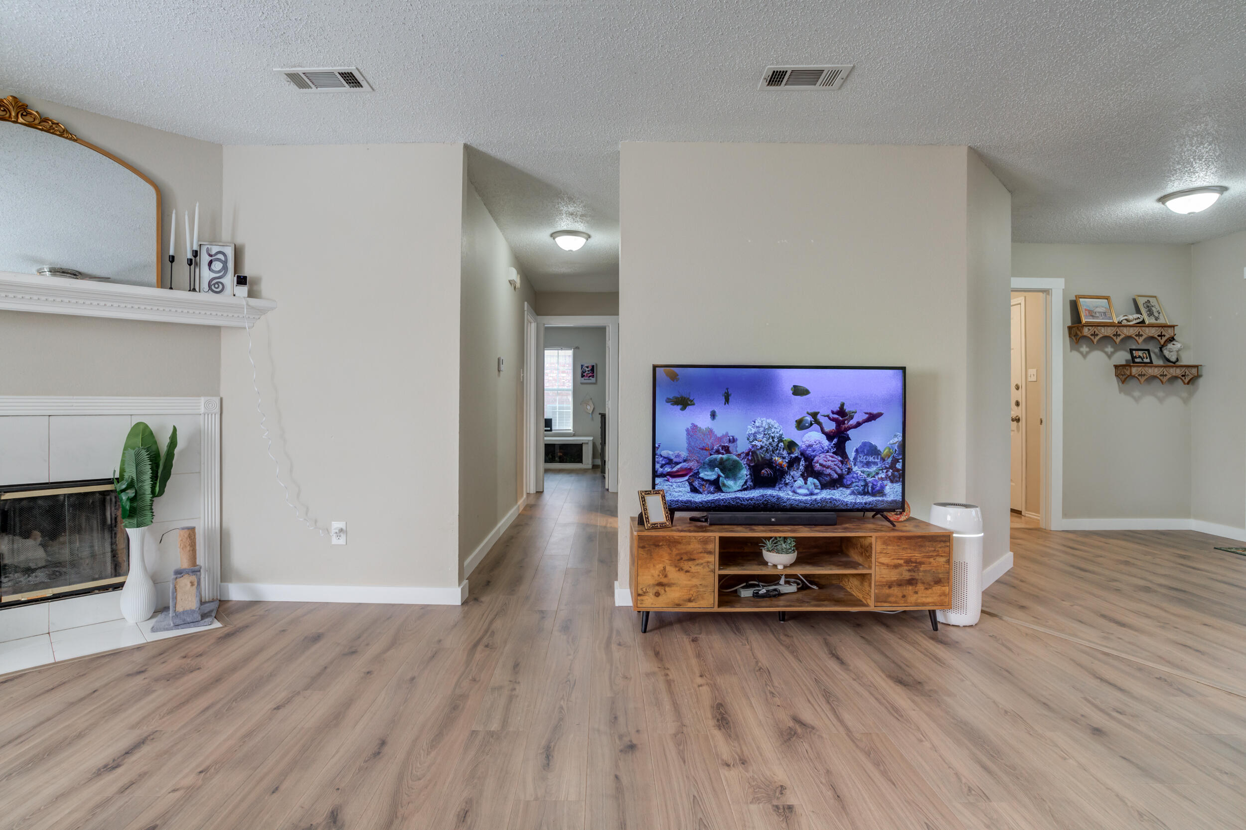 8406 Canton Avenue Lubbock, TX 79423 - Photo 12 of 25 a living room with furniture and a wooden floor