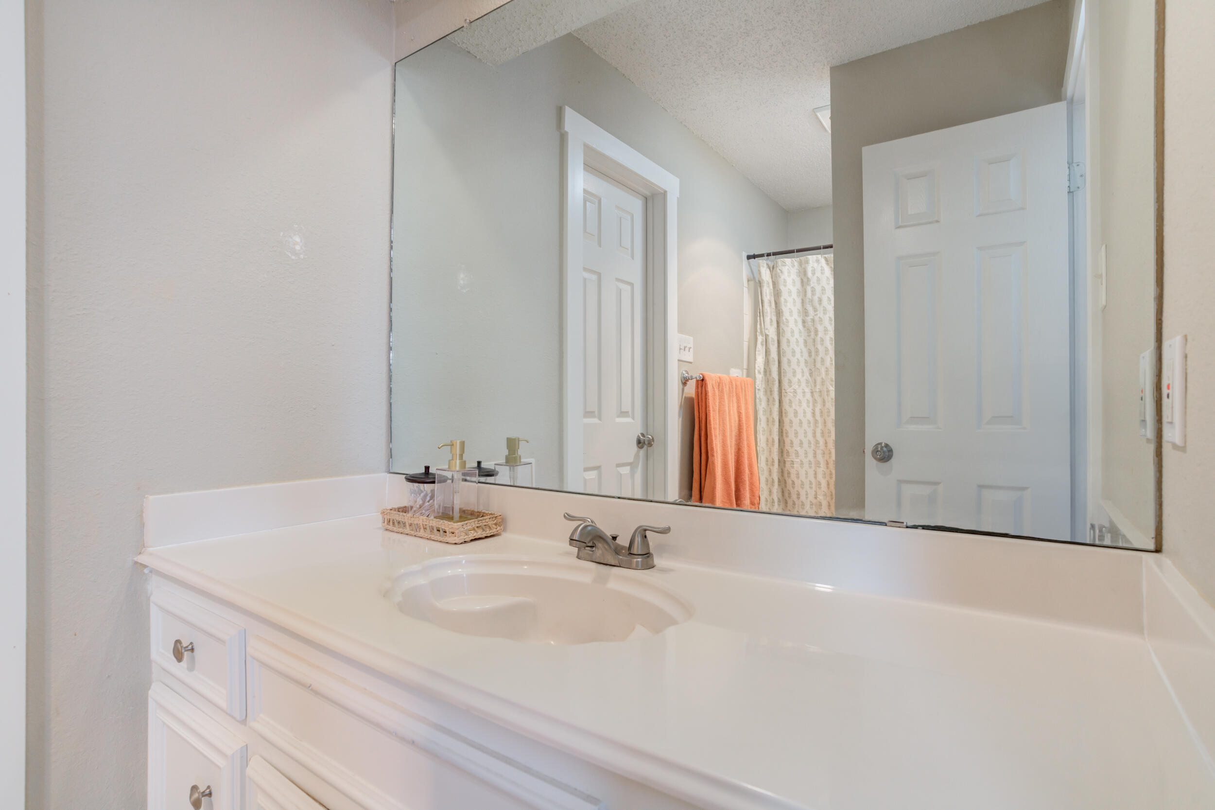 8406 Canton Avenue Lubbock, TX 79423 - Photo 14 of 25 a bathroom with a sink and a mirror