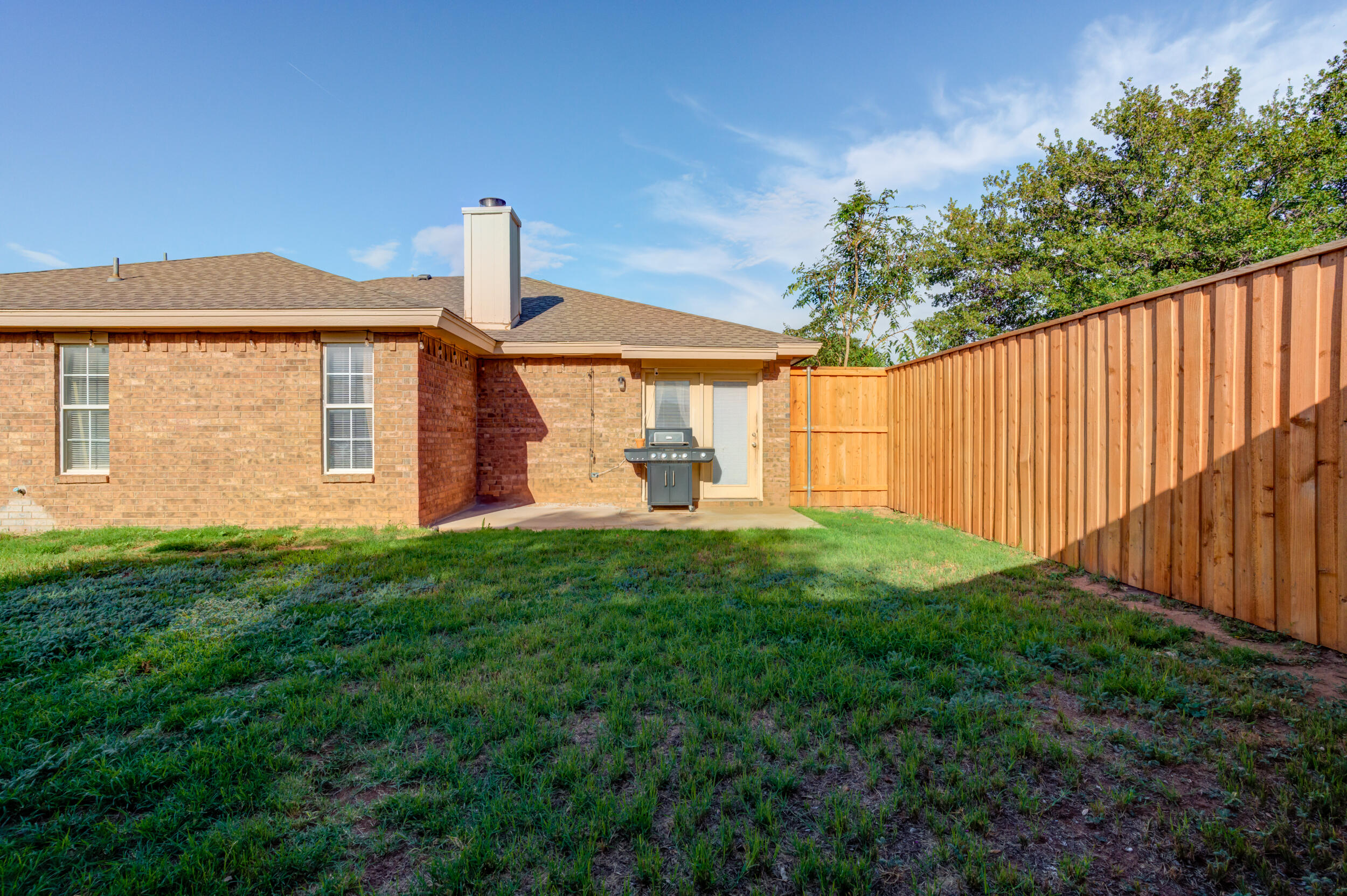 8406 Canton Avenue Lubbock, TX 79423 - Photo 21 of 25 a front view of a house with garden