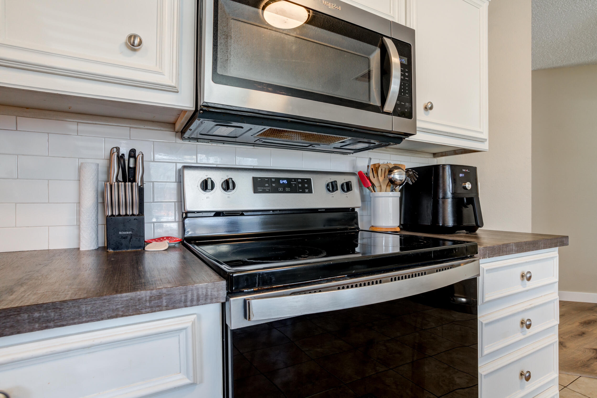 8406 Canton Avenue Lubbock, TX 79423 - Photo 6 of 25 a kitchen with stainless steel appliances granite countertop a stove and a microwave