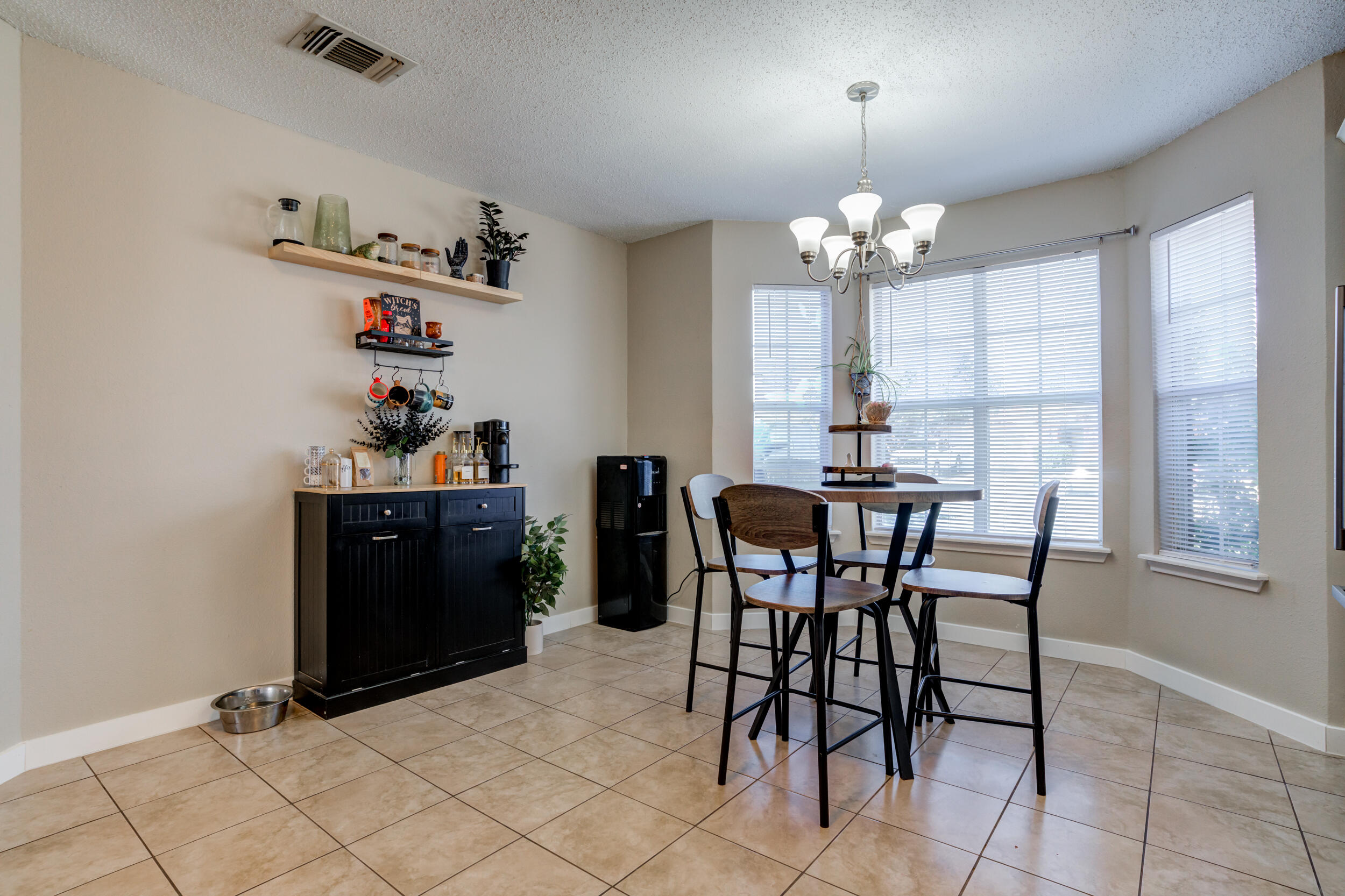 8406 Canton Avenue Lubbock, TX 79423 - Photo 7 of 25 a view of a dining room with furniture and chandelier