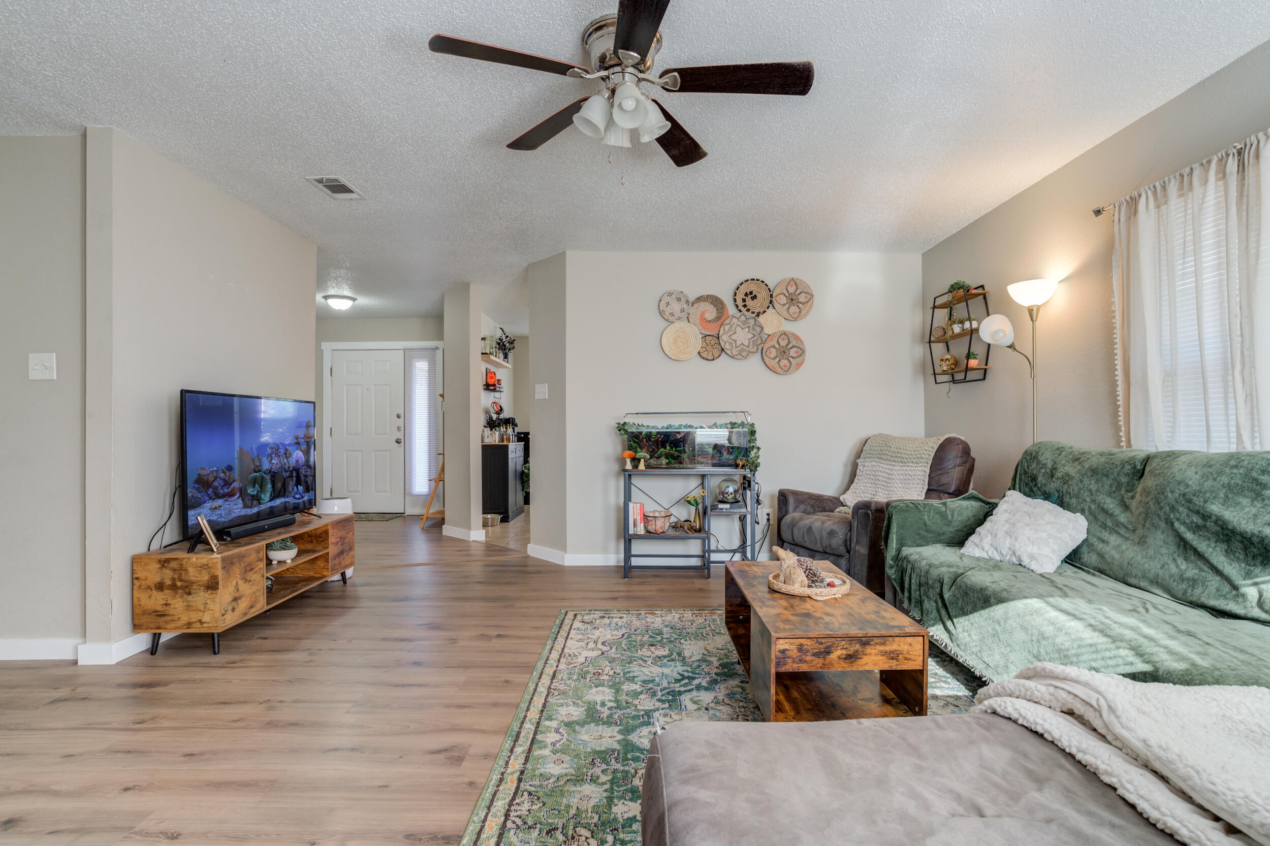 8406 Canton Avenue Lubbock, TX 79423 - Photo 10 of 25 a living room with furniture and a flat screen tv