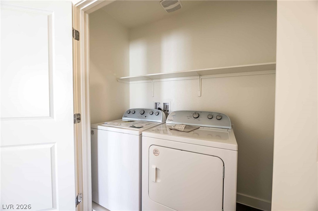 12749 Epperly Street Henderson, NV 89044 - Photo 19 of 22 A dedicated laundry space provides optimal clothes care with a convenient shelf for supplies.