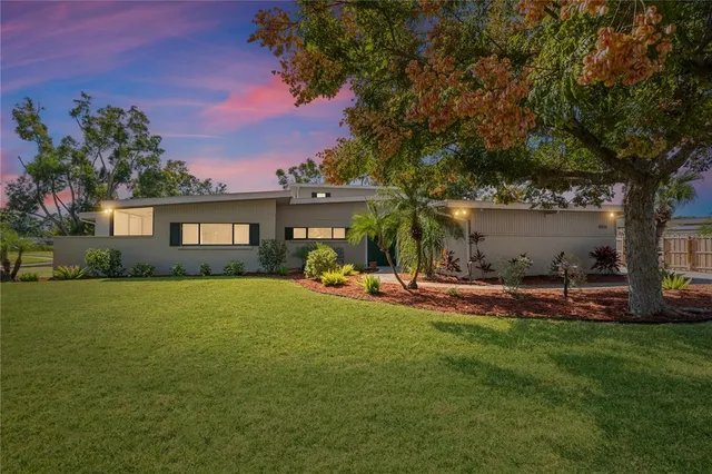 a view of a house with a yard and sitting area