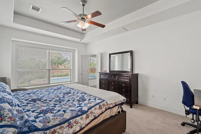 a bedroom with a large bed and a tv