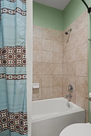 a bathroom with a bathtub and shower
