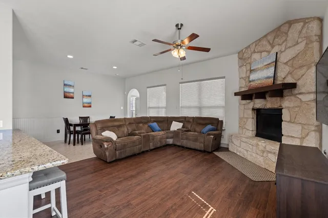 a living room with furniture and a fireplace