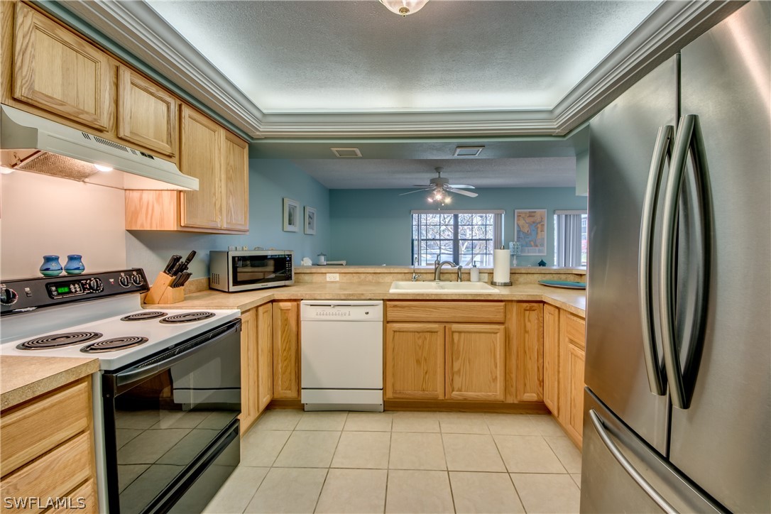 23465 Harbor View Road, Unit 1008 Port Charlotte, FL 33980 - Photo 11 of 33 a kitchen with a sink cabinets and stainless steel appliances