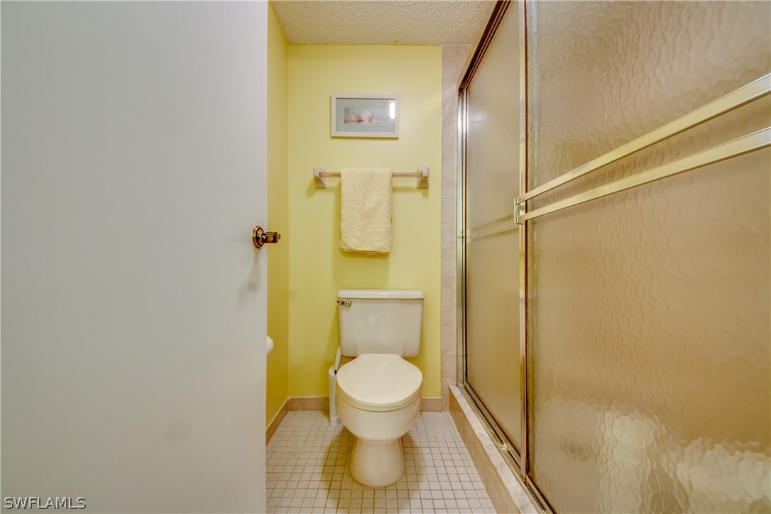 23465 Harbor View Road, Unit 1008 Port Charlotte, FL 33980 - Photo 16 of 33 a bathroom with a toilet and a shower