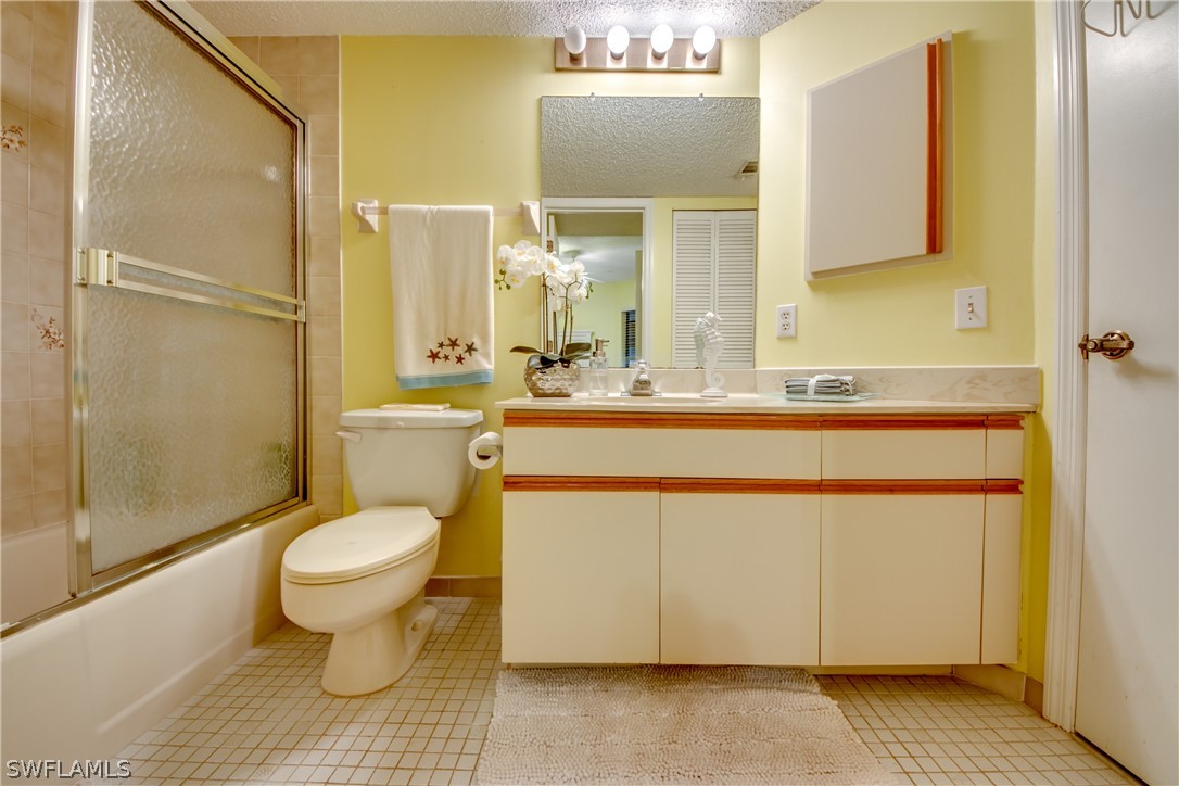 23465 Harbor View Road, Unit 1008 Port Charlotte, FL 33980 - Photo 18 of 33 a bathroom with a sink toilet a mirror and shower