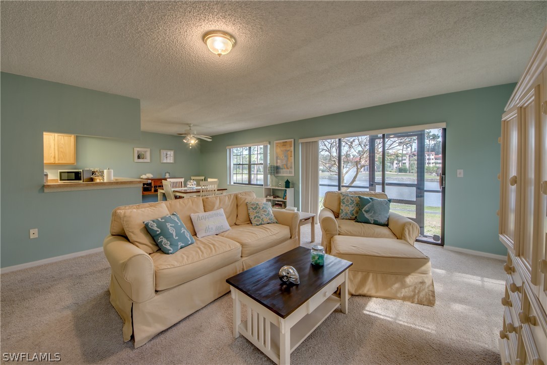 23465 Harbor View Road, Unit 1008 Port Charlotte, FL 33980 - Photo 6 of 33 a living room with furniture and a large window