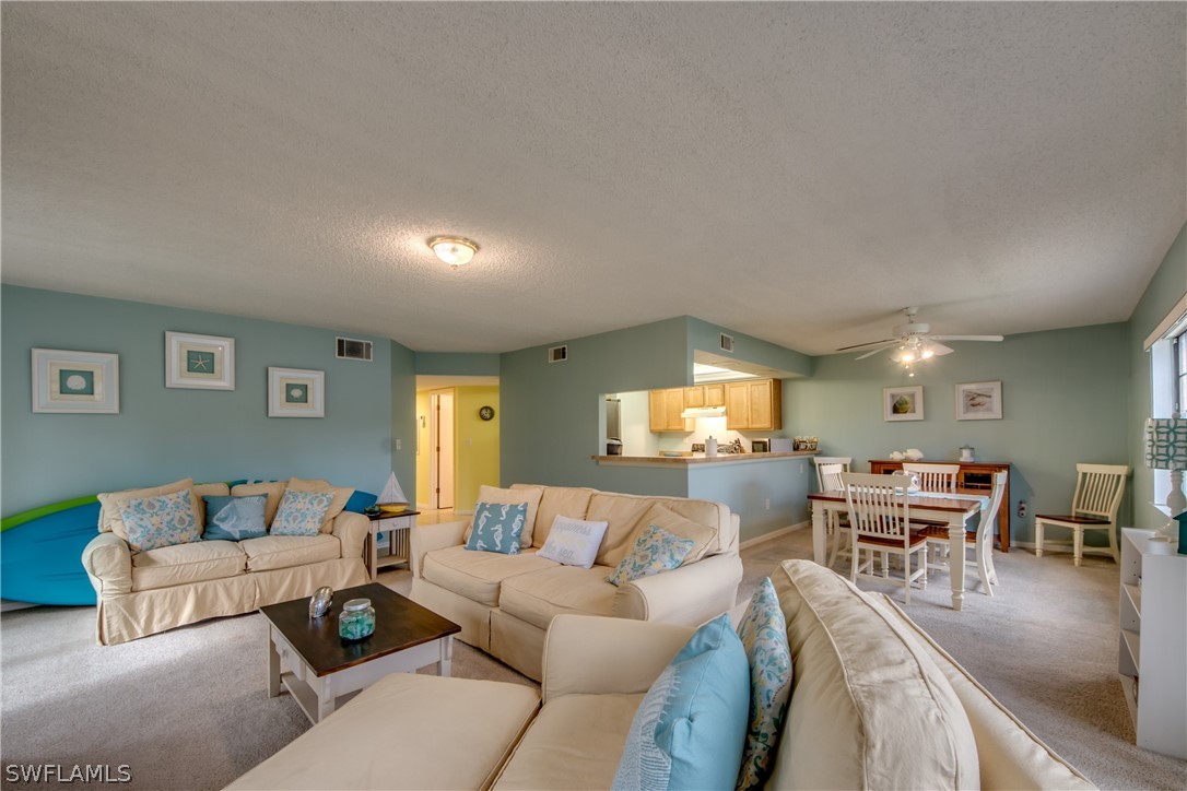 23465 Harbor View Road, Unit 1008 Port Charlotte, FL 33980 - Photo 8 of 33 a living room with furniture and a large window