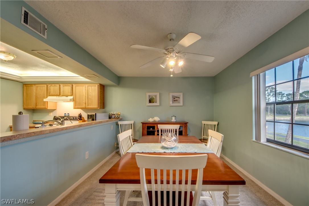 23465 Harbor View Road, Unit 1008 Port Charlotte, FL 33980 - Photo 9 of 33 a view of a dining room with furniture window and wooden floor