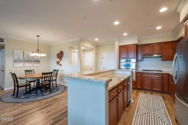 a living room with furniture and a dining table