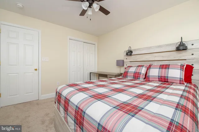 a bedroom with a bed and a mirror