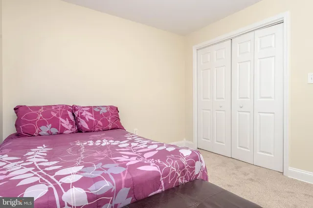 a bedroom with a bed and a night stand