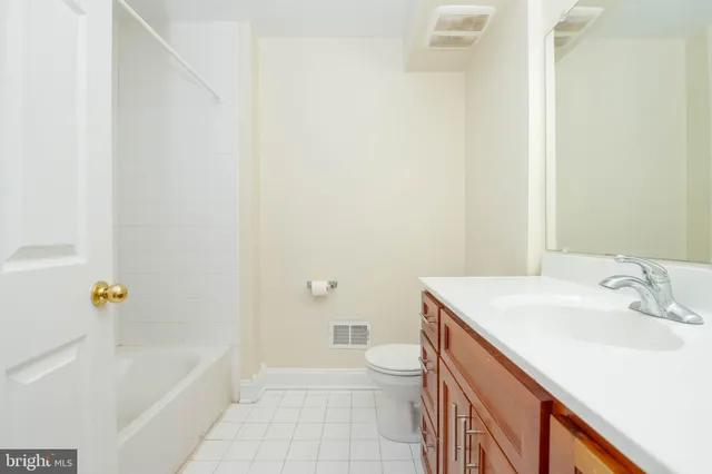 a bathroom with a sink a toilet and bathtub