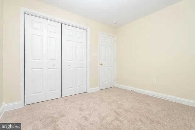 an empty room with closet area