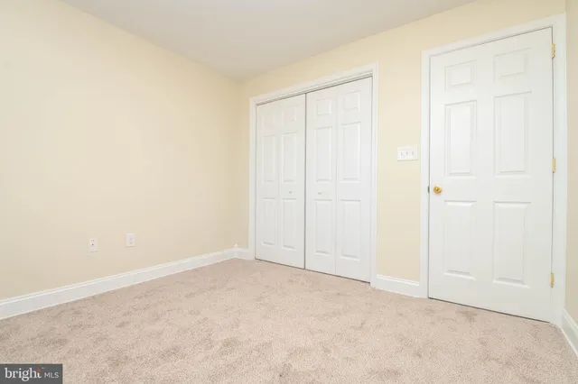 an empty room with closet area