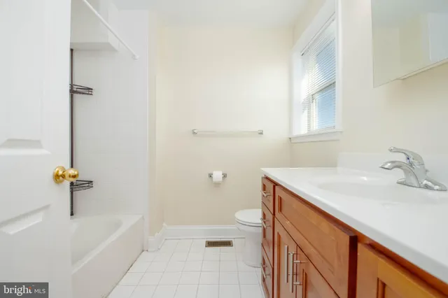 a bathroom with a sink a toilet and bathtub