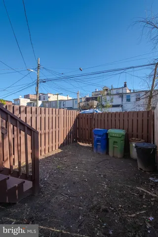 a view of a backyard with wooden fence