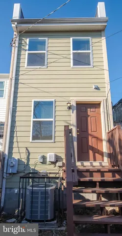 a view of house with wooden deck and furniture