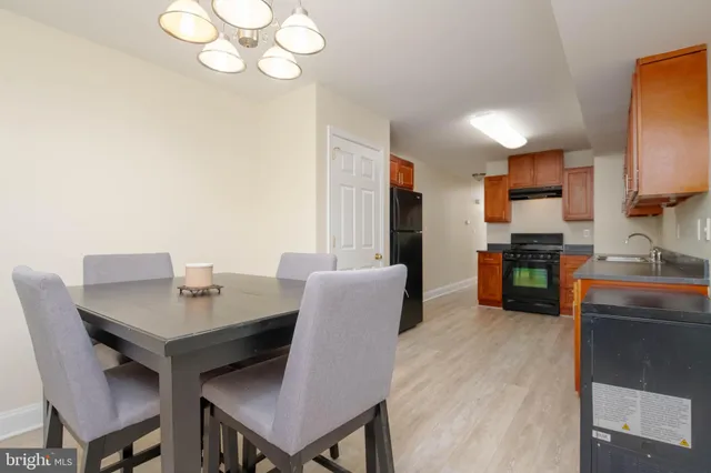 a kitchen with a table chairs and refrigerator