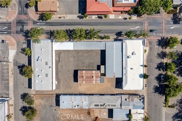 an aerial view of residential houses with outdoor space and lake view