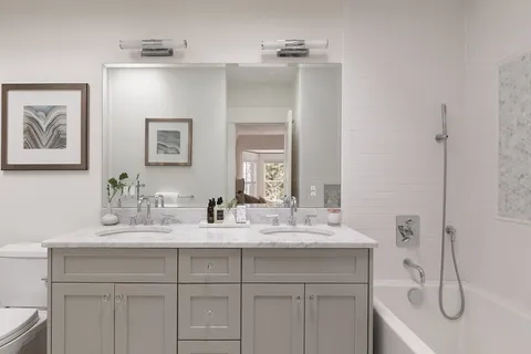 a bathroom with a sink a vanity and a mirror