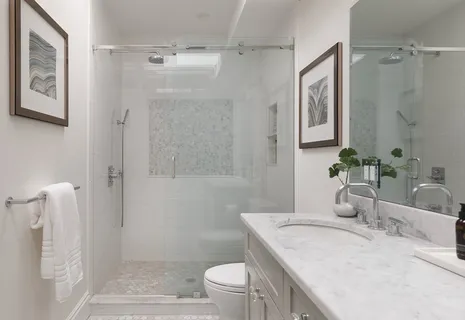 a bathroom with a granite countertop sink a toilet and shower