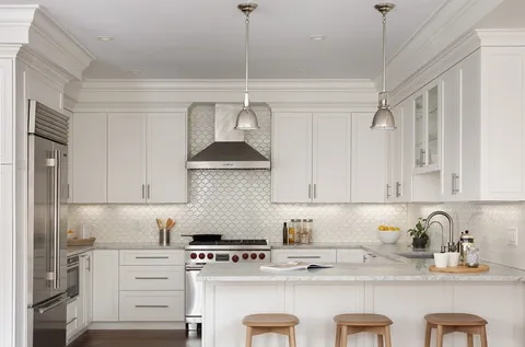 a kitchen with stainless steel appliances a sink a stove and cabinets