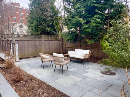 a view of a backyard with sitting area