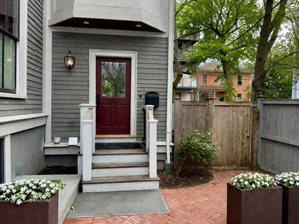 a front view of a house with a garden