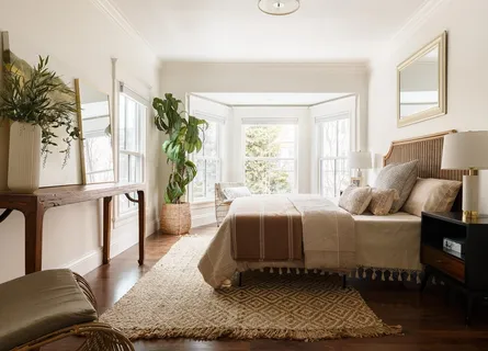 a living room with a bed furniture and a window
