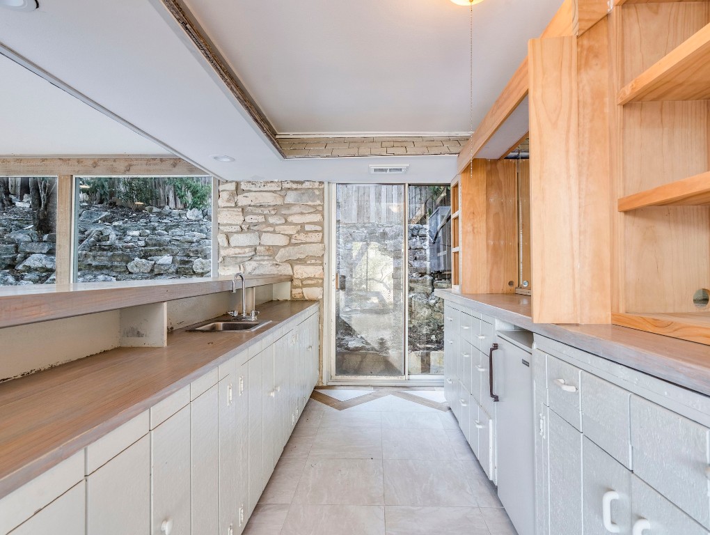 236 Cedar Hurst Lane Austin, TX 78734 - Photo 13 of 31 a kitchen with stainless steel appliances a sink and a large window