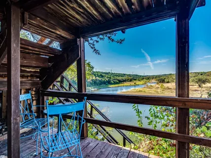 a view of a house with a backyard and trees