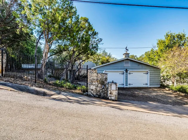 a view of a house with a trees front yard