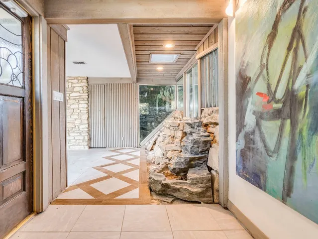 a large kitchen with a sink and a large window